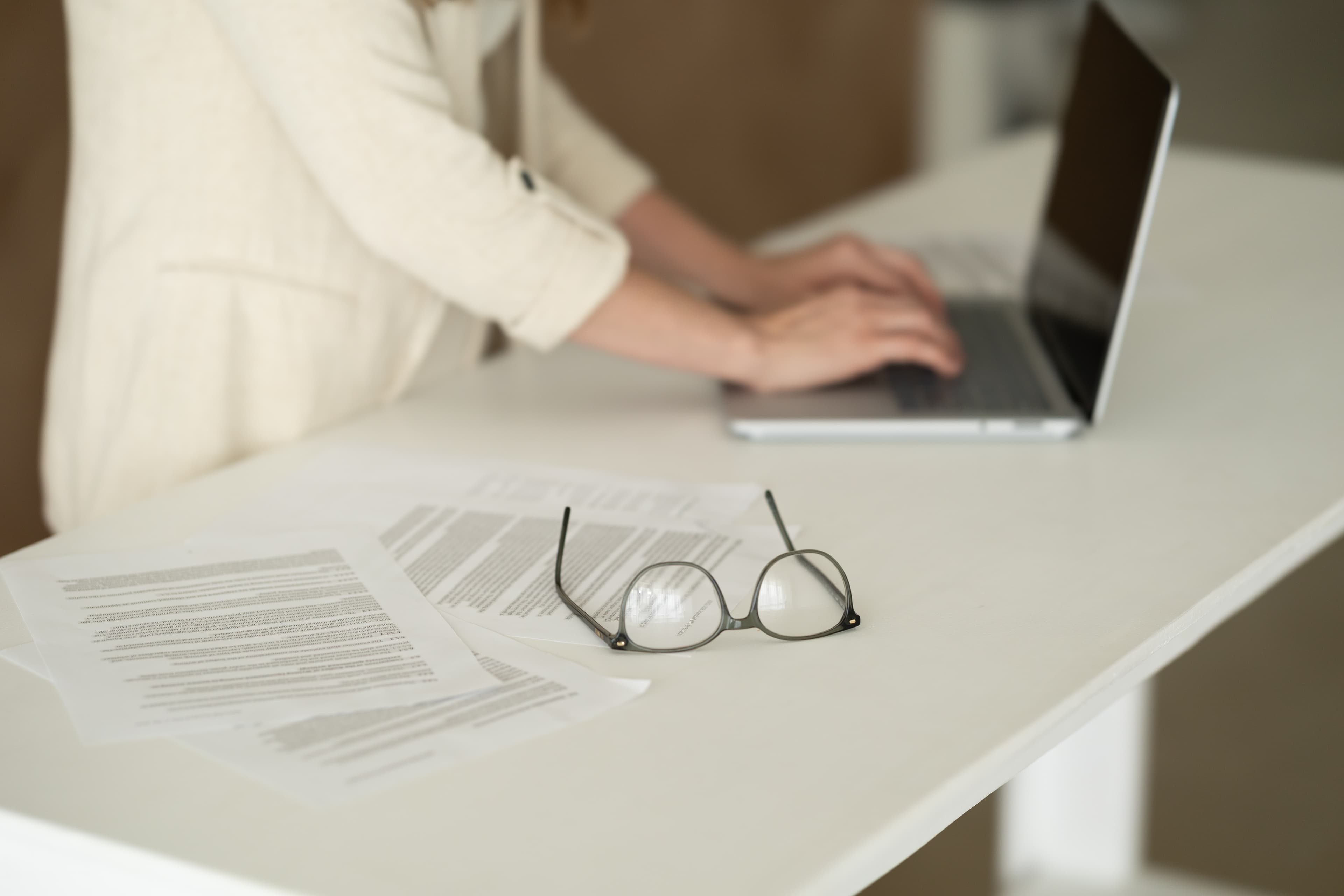 Documents and reading glasses during a case examination